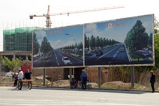 21 Donkey Cart Next To Advertising For Cars On New Paved Roads In Karghilik Yecheng At The Junction Of China National Highways 315 And G219.jpg
